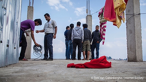Men re-wiring a building after the 2015 earth quake in Nepal